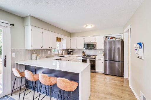Kitchen remodel in 2022 with quartz countertops, backsplash, undermount sink, and new appliances!