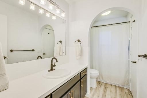Upper level full bathroom with newer toilet and fixtures.