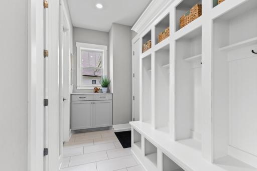 A spacious mudroom featuring custom built-ins for organized storage