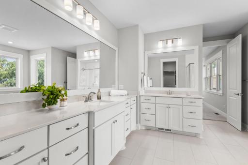 Primary bathroom features a spa-inspired ensuite bath with soaking tub, walk-in shower, and spacious walk-in closet