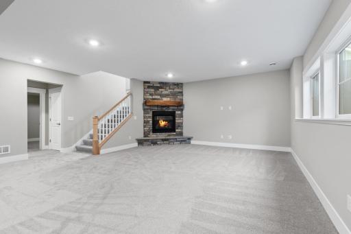 The lower level is enhanced by a fireplace, creating a cozy gathering space.