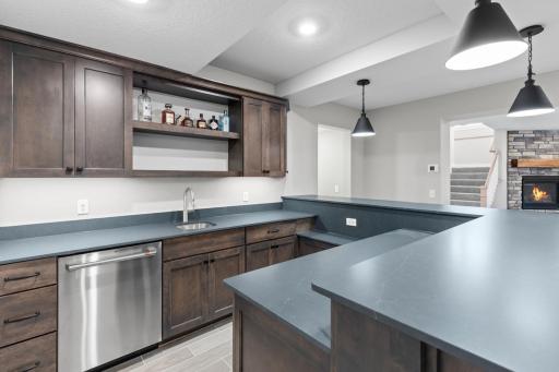 The wet bar offers ample counter and cabinet space, perfect for entertaining