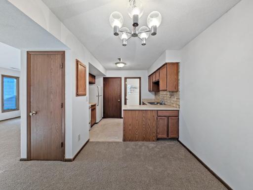Dining area and kitchen on main level with a half bath and laundry.