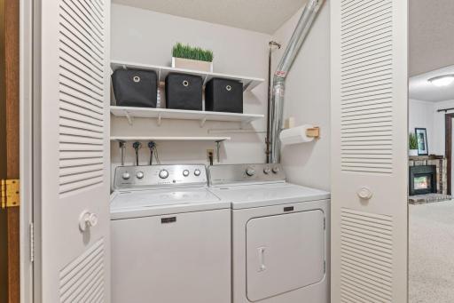 Convenient laundry with shelving for storage and organization.