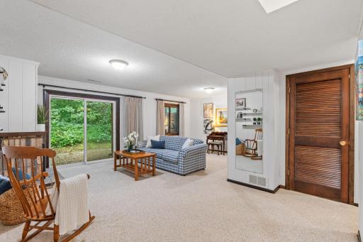 Inviting lower level family room with walk-out to a wooded backyard.