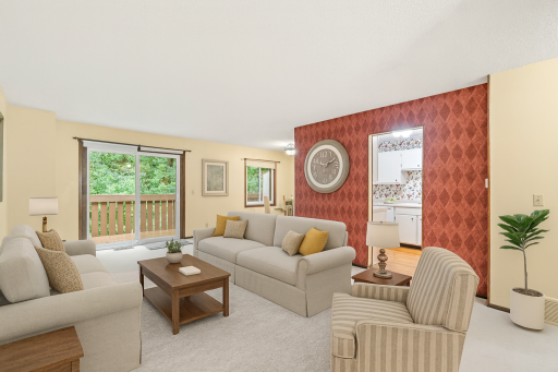 Spacious living room with patio door to deck - plenty of natural light! *This photo has been virtually staged*