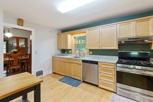 This spacious kitchen features abundant maple cabinetry, sleek stainless steel appliances, large pantry and beautiful granite countertops.