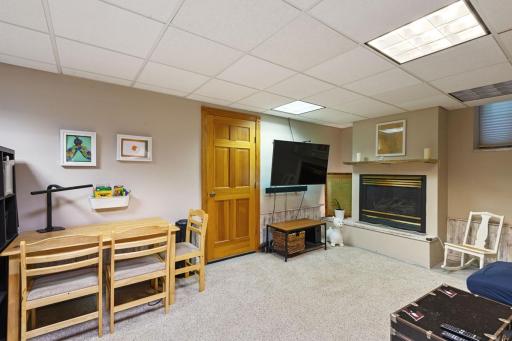 The lower-level family room is versatile space for relaxing, watching movies, or hobbies. A great spot for casual living and gatherings.