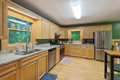 Large windows bring in natural light and offer scenic views, creating a bright and functional space ideal for everyday living and meal preparation.