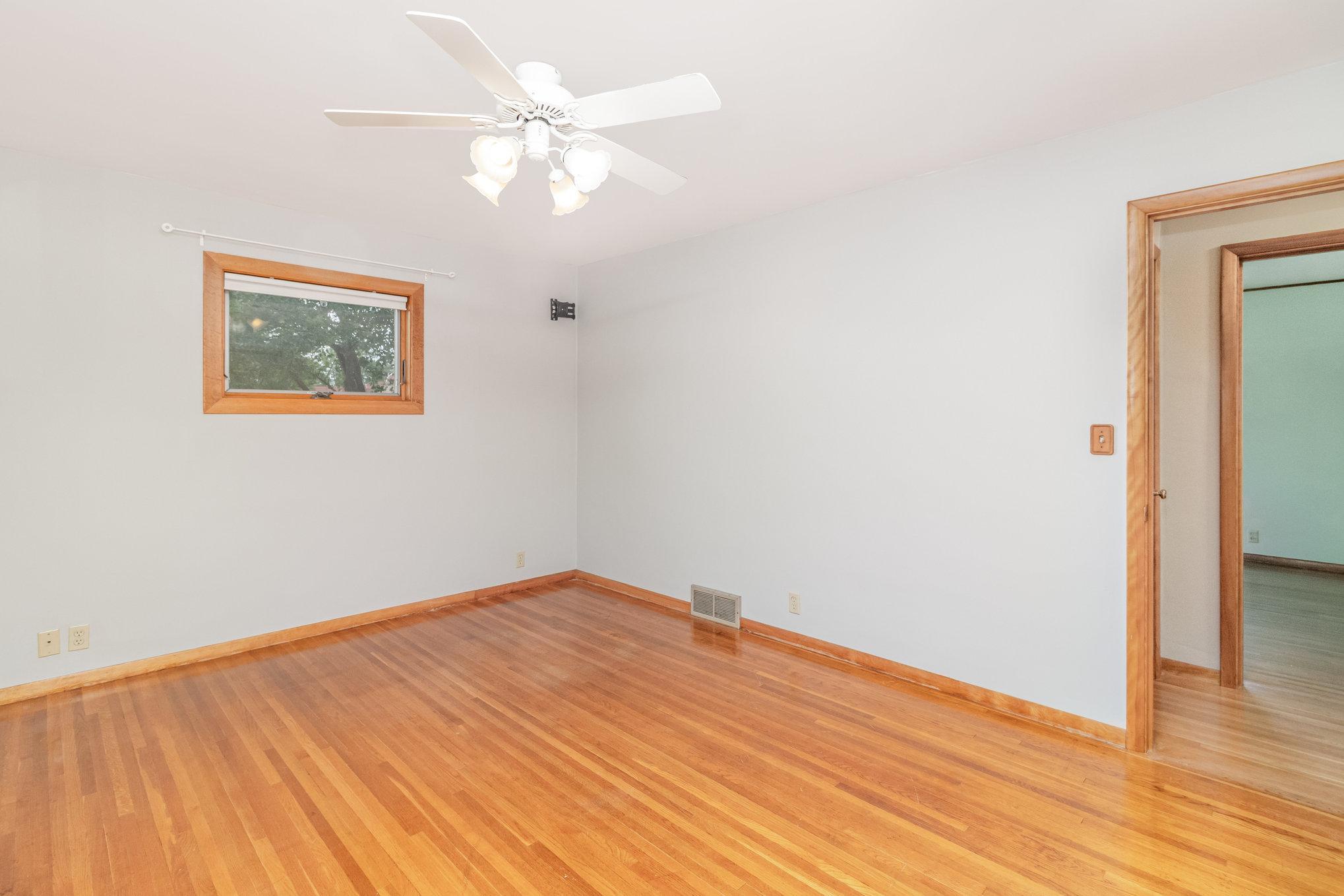 Bedrooms on the main floor feature refinished oak floors & ceiling fans.