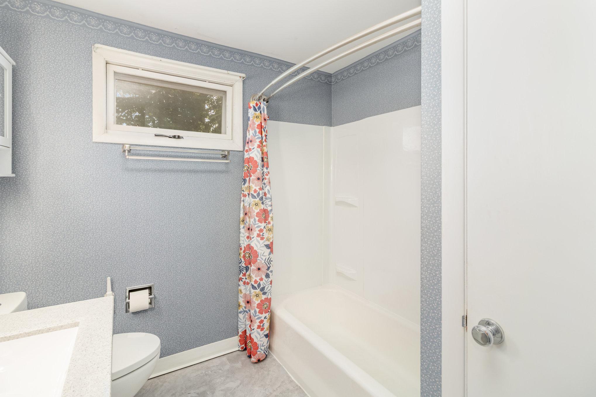 Upper level full bath has new shower, stool, vanity, flooring & lighting.