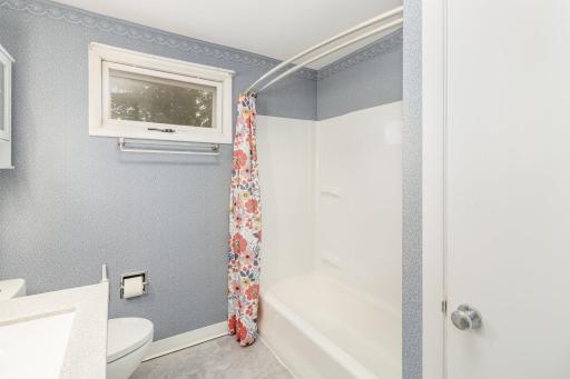 Upper level full bath has new shower, stool, vanity, flooring & lighting.
