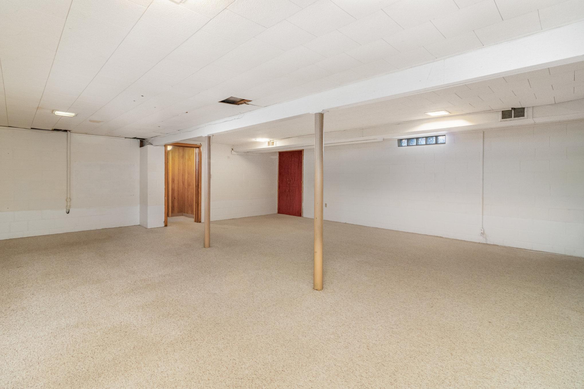 Second view of rec room in basement.