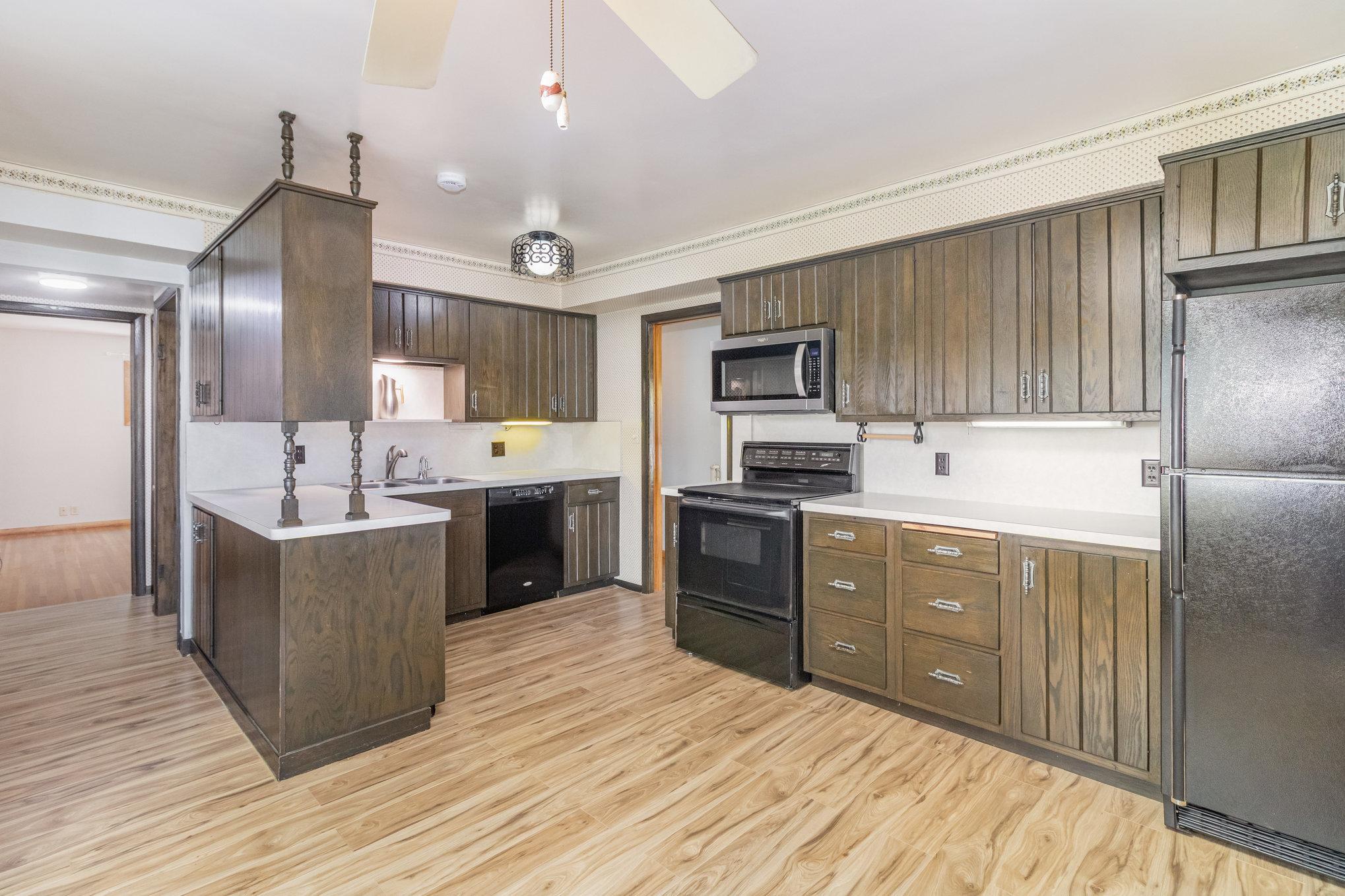 Pull out shelving in the kitchen with solid oak cabinetry + pull out appliance cabinet.