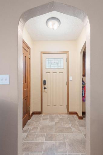 Lovely entry with original door to closet and arches!