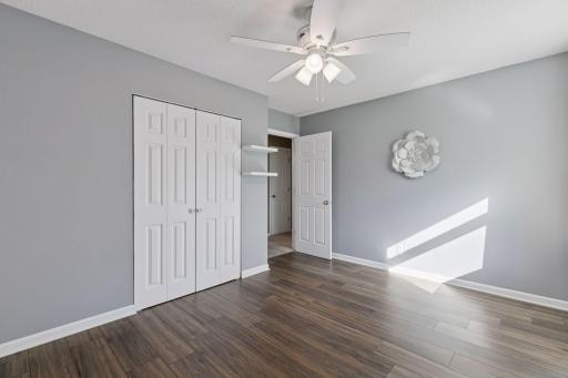 Bedroom 1 - largest of the three, laminate hardwood, ceiling fan, 6 panel white doors and trim.