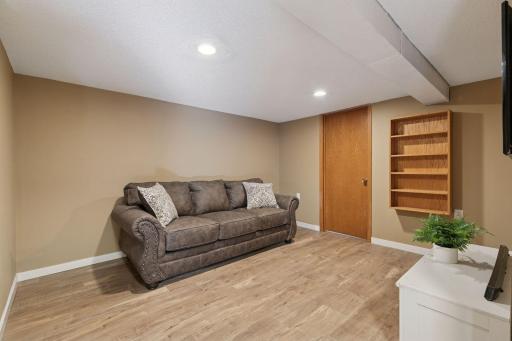 Really attractive floors, wall shelving, and door to storage room.