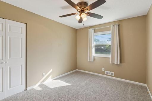 Bedroom 2- ceiling fan, white trim, plush carpet