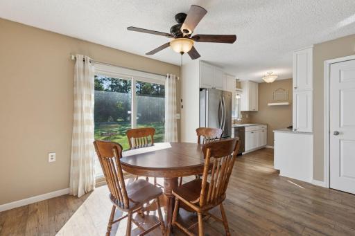 Adjacent to the kitchen, the dining area showcases gorgeous laminate hardwood flooring and flows seamlessly into the backyard through glass patio doors.