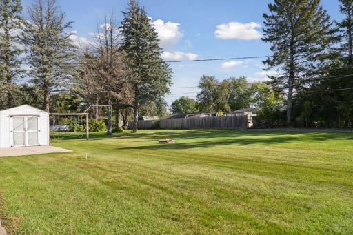 Expansive flat backyard. A row of trees provides some privacy from neighbors to the rear of the home.