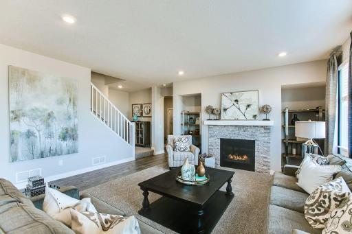 Open main level but actual home has upgraded hard floors in the living room. *Photos of a similar home. Colors and options will vary.