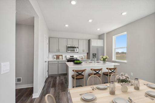 Great eat-in kitchen with spacious island and walk in pantry. Photo of model home, color & options will vary.
