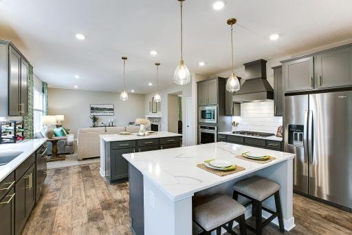 Entertainer's dream kitchen with two large islands and a gourmet kitchen filled with light and high end appliances. *Photo of previously built model home. Finishes and selections to vary.