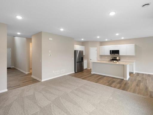 Open Concept Living Space. Photo taken of another home with similar plan and finishes. Photos and renderings may not depict actual plan, materials, & finishes may vary. All measurements are approximate.