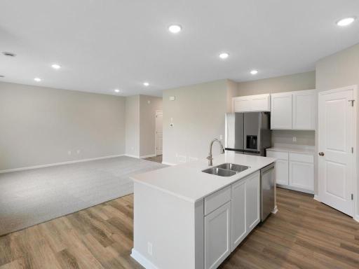 Kitchen. Photo taken of another home with similar plan and finishes. Photos and renderings may not depict actual plan, materials, & finishes may vary. All measurements are approximate.