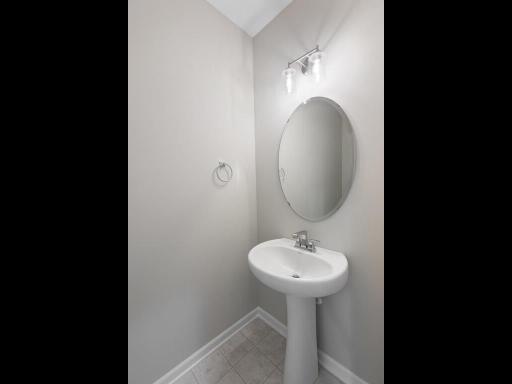 Main Level Powder Bathroom. Photo taken of another home with similar plan and finishes. Photos and renderings may not depict actual plan, materials, & finishes may vary. All measurements are approximate.