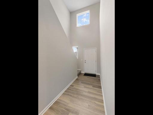 Open Two Story Foyer. Photo taken of another home with similar plan and finishes. Photos and renderings may not depict actual plan, materials, & finishes may vary. All measurements are approximate.
