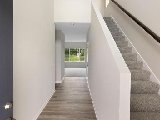 Open Two Story Foyer. Photo taken of another home with similar plan and finishes. Photos and renderings may not depict actual plan, materials, & finishes may vary. All measurements are approximate.