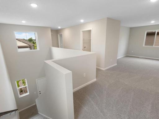 Upper Level Landing. Photo taken of another home with similar plan and finishes. Photos and renderings may not depict actual plan, materials, & finishes may vary. All measurements are approximate.