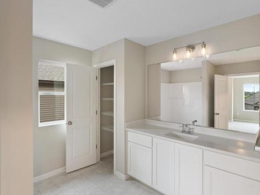 Private Primary Bathroom. Photo taken of another home with similar plan and finishes. Photos and renderings may not depict actual plan, materials, & finishes may vary. All measurements are approximate.