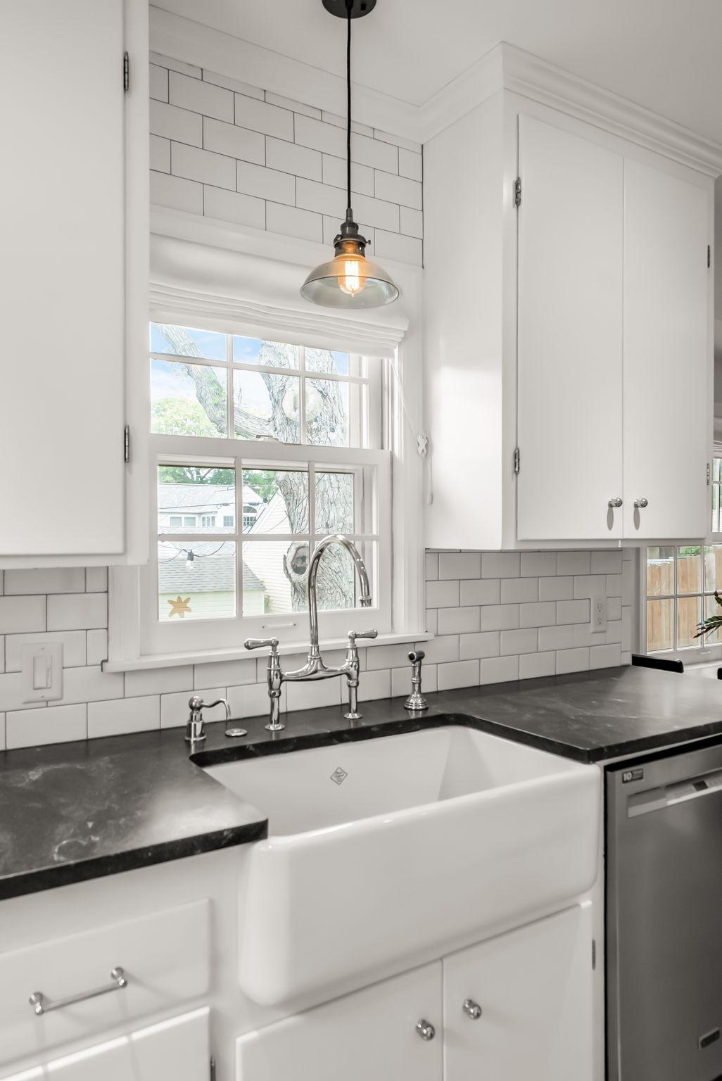 The kitchen features thoughtful and high end updates throughout, including a Shaws of Darwen handcrafted porcelain sink and a Perrin and Rowe silver faucet from England.