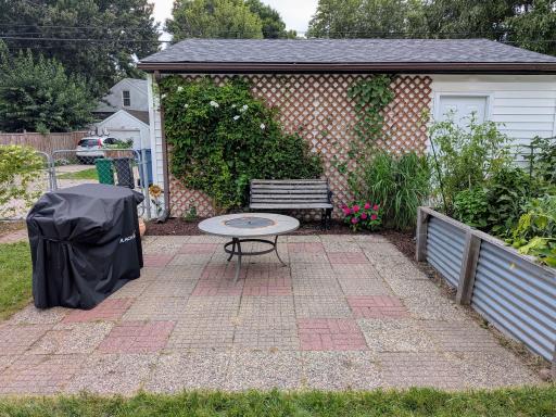 Great patio for grilling and entertaining. Check out the huge raised garden bed just to the right.