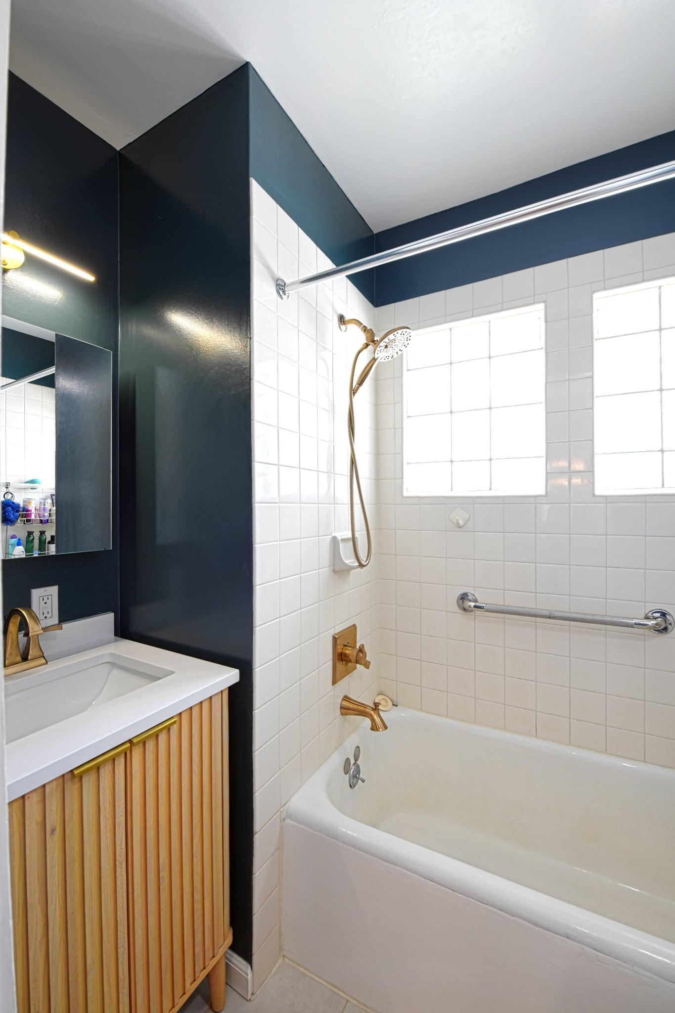 Updated and modern full bath with glass block windows.