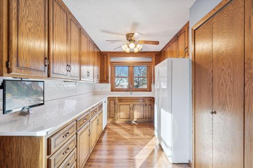 Storage is abundant in the kitchen with many cabinets, drawers, large pantry, quartz countertops, and gas stove.
