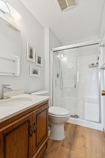 Primary bath with glass shower & quartz countertop
