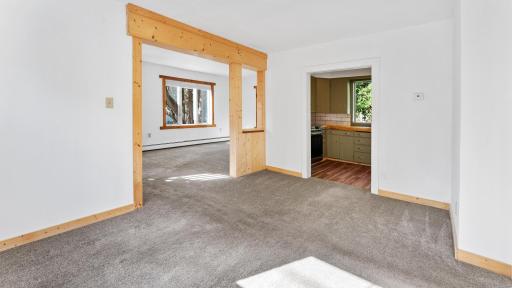 Dining space looking into living room and kitchen