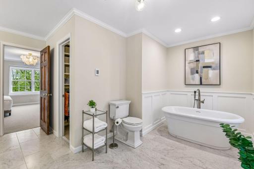 Primary bathroom with soaking tub and walk-in closet
