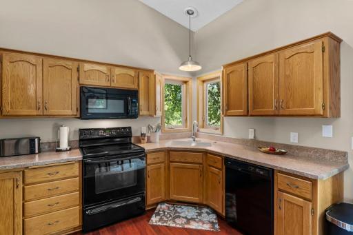 The kitchen includes beautiful natural woodwork and plenty of cabinet space.