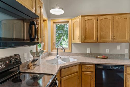The kitchen includes beautiful natural woodwork and plenty of cabinet space.