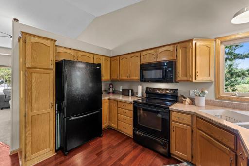 The kitchen includes beautiful natural woodwork and plenty of cabinet space.