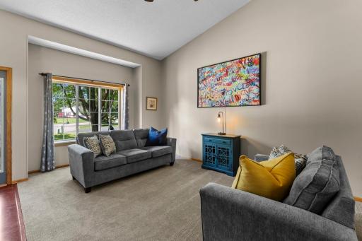 The living room features soaring vaulted ceilings.