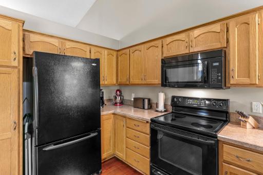 The kitchen includes beautiful natural woodwork and plenty of cabinet space.