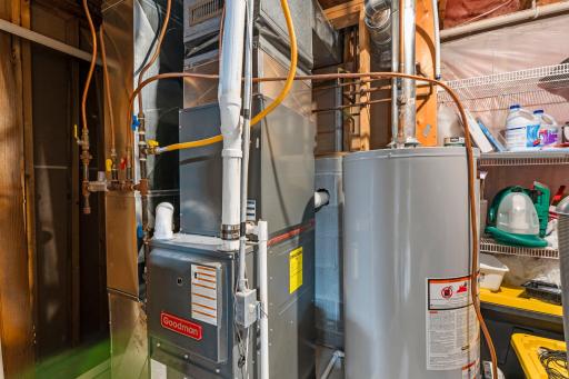 The utility room includes additional storage space and shelving.