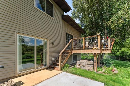 The backyard includes both a deck and a concrete patio.