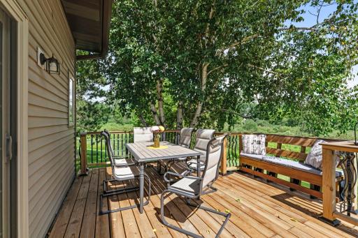 The deck overlooks the gorgeous backyard.