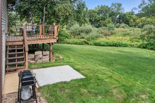 The backyard includes both a deck and a concrete patio.